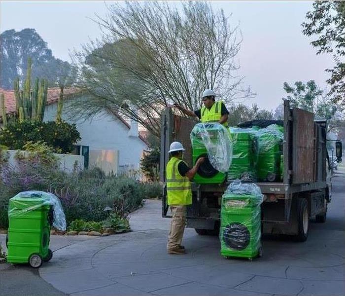 SERVPRO technicians transporting air filters 